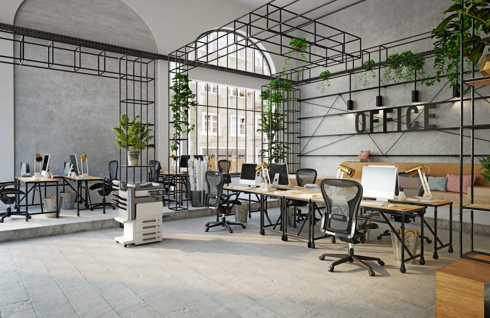 Modern office interior with desks, computers, chairs, and indoor plants